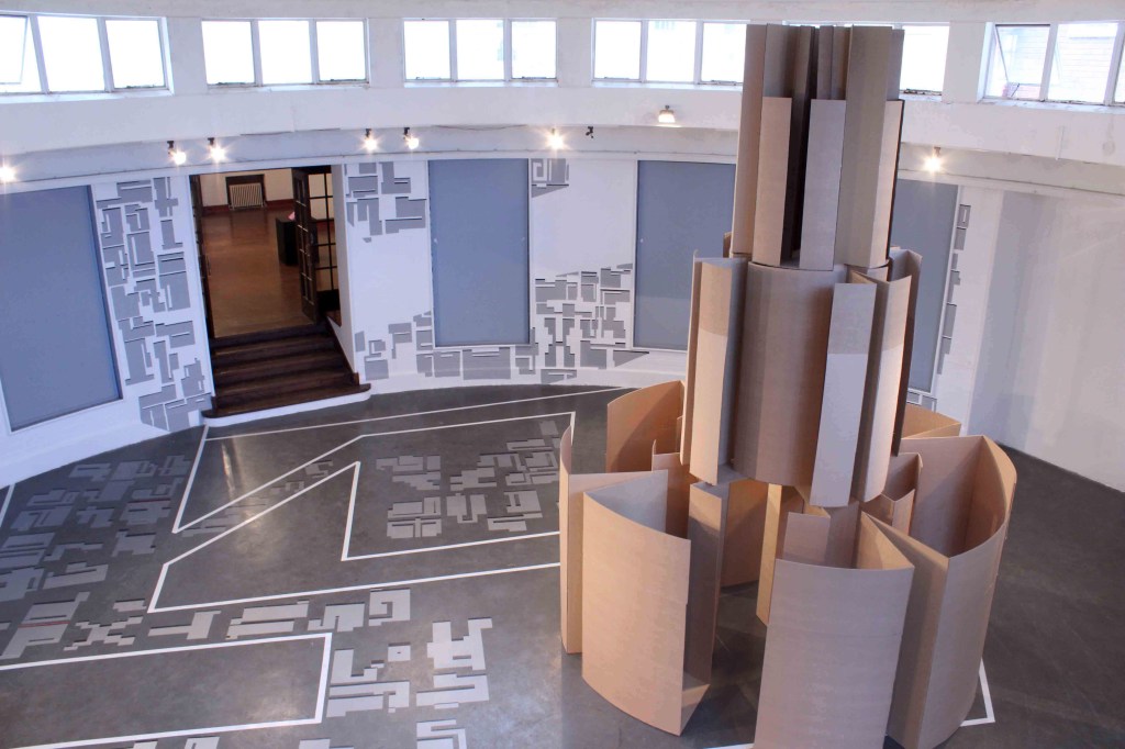 Installation view of Sandile Radebe’s “A Walk in the City” (2014), featuring abstract sculptural forms inspired by graffiti tags, exhibited in the circular gallery space of the National School of the Arts in Braamfontein.
